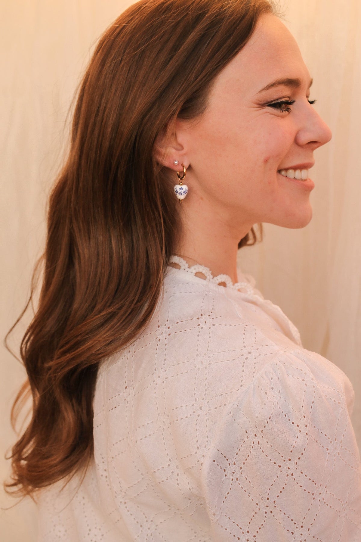 Blue hoop earring viewed from the side, showing the slim profile