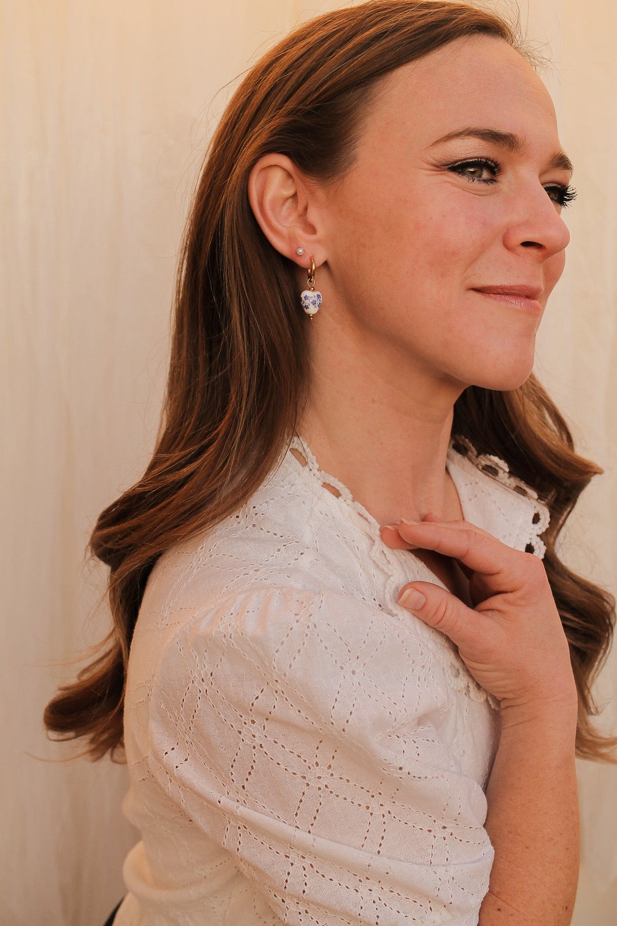 Blue hoop earrings shown at an angle to display the curve