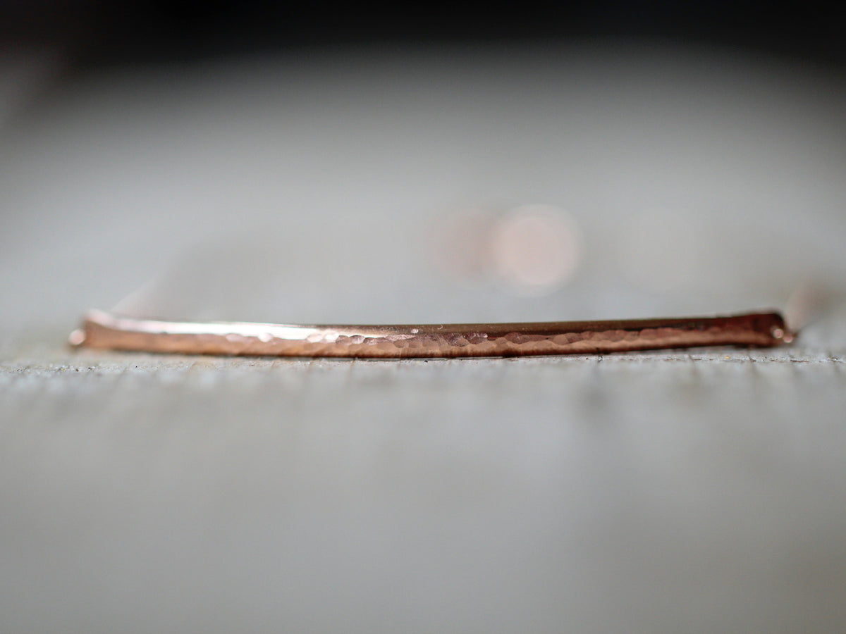 Close-up of a polished bar choker necklace, simple contemporary design for daily wear