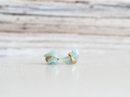 Aquamarine stud earrings with a moon and star motif, shown as a pair