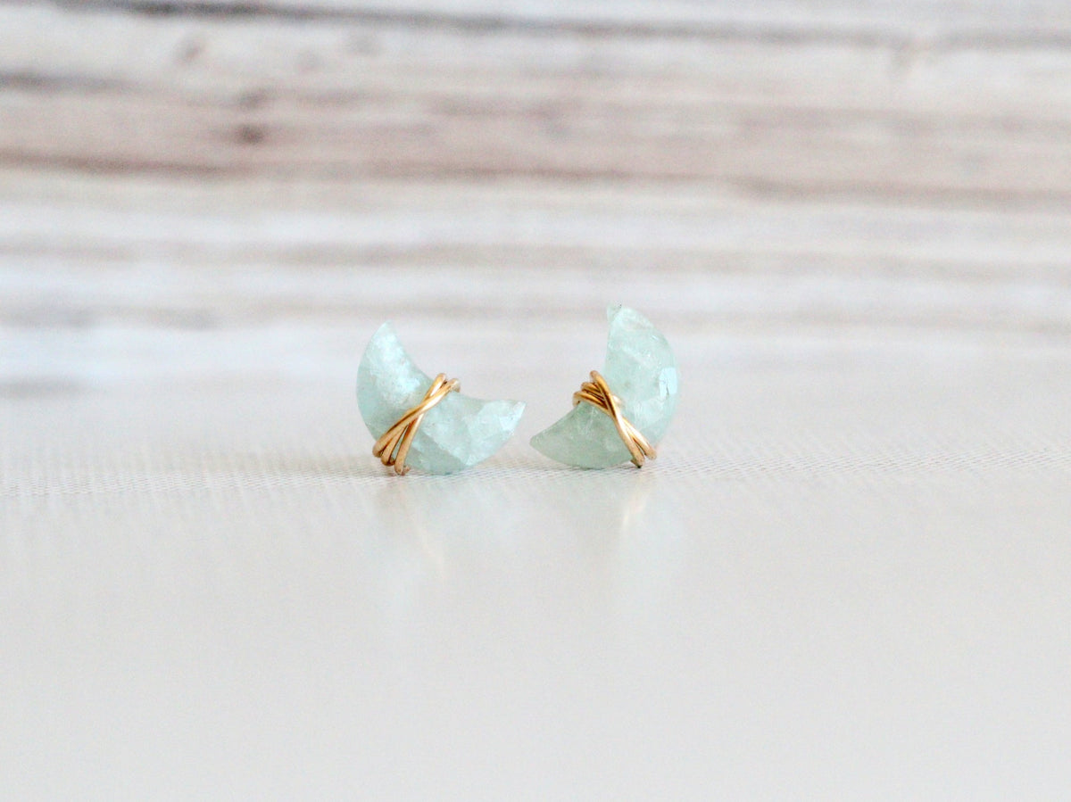 Aquamarine stud earrings featuring moonbeam and stardust detailing