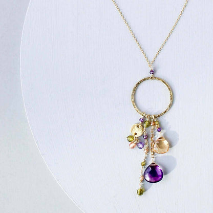 The Ammil Necklace - Amethyst &amp; CitrineThe ultimate gemstone pendant. Multiple strands of glimmering amethyst, citrine and peridot gemstones hang from our signature gold circle. Handmade with 14k gold plaNecklacesPARKEN JEWELRYVettedArcThe Ammil Necklace