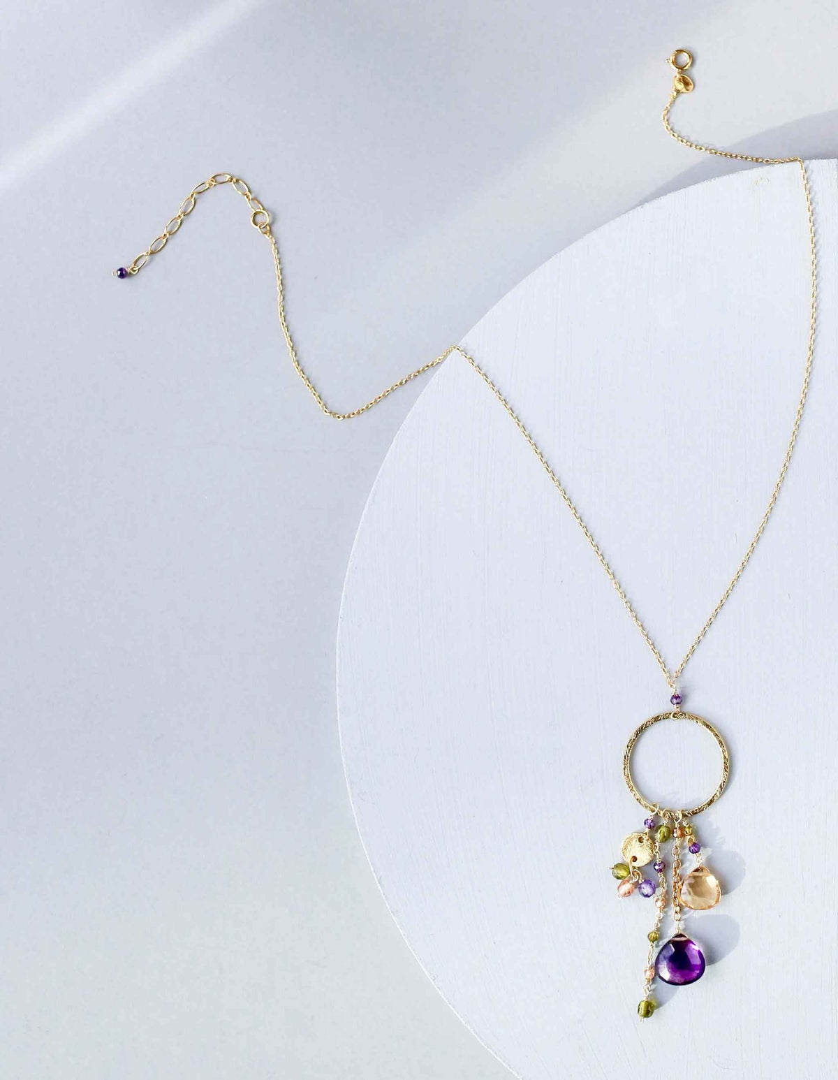 The Ammil Necklace - Amethyst &amp; CitrineThe ultimate gemstone pendant. Multiple strands of glimmering amethyst, citrine and peridot gemstones hang from our signature gold circle. Handmade with 14k gold plaNecklacesPARKEN JEWELRYVettedArcThe Ammil Necklace