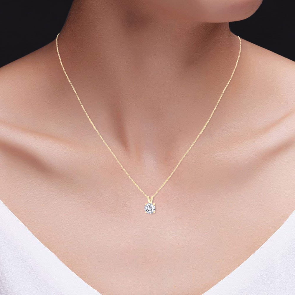 Round moissanite solitaire pendant on 14k gold chain, angled to show sparkle