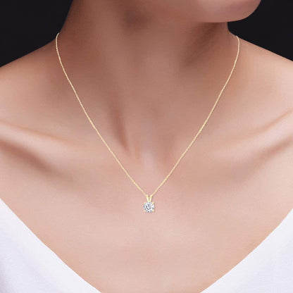 Round moissanite solitaire pendant on 14k gold chain, angled to show sparkle