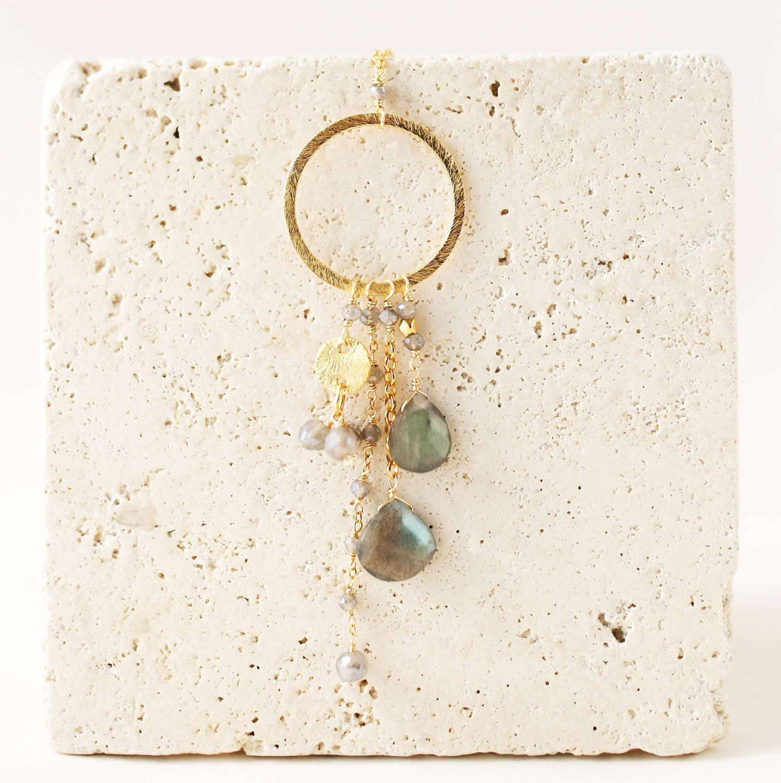 The Ammil Necklace featuring a labradorite gemstone pendant with multi-strand combinations on a 14k gold plated hoop