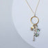 The Ammil Necklace featuring a labradorite gemstone pendant with multi-strand gemstone details on a 14k gold plated hoop.