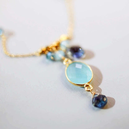 Gold bezel necklaces with gemstone pendants on delicate chains