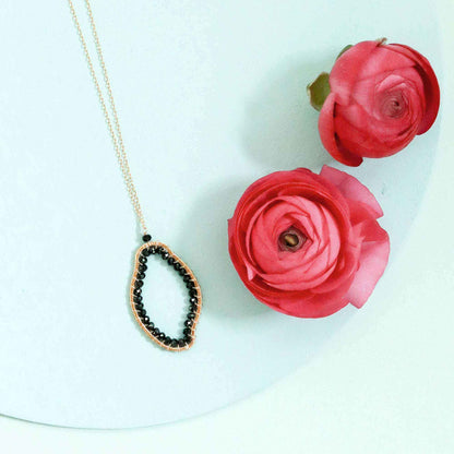 Black Spinel freestyle pendant necklace with unique abstract design on delicate gold-plated sterling silver chain