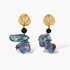 Ornate gold-plated drop earrings with black beads and iridescent blue-purple baroque pearls against white background.