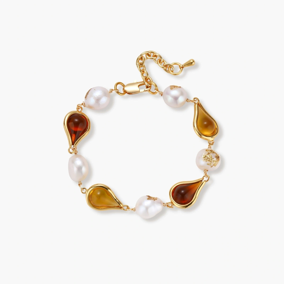 Gold plated bracelet with amber and honey teardrop stones, baroque freshwater pearls with gold flecks, and an adjustable chain.