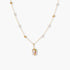 Delicate 18k gold-plated chain with baroque pearls and colorful enamel pendant featuring blue, pink accents on cream background.