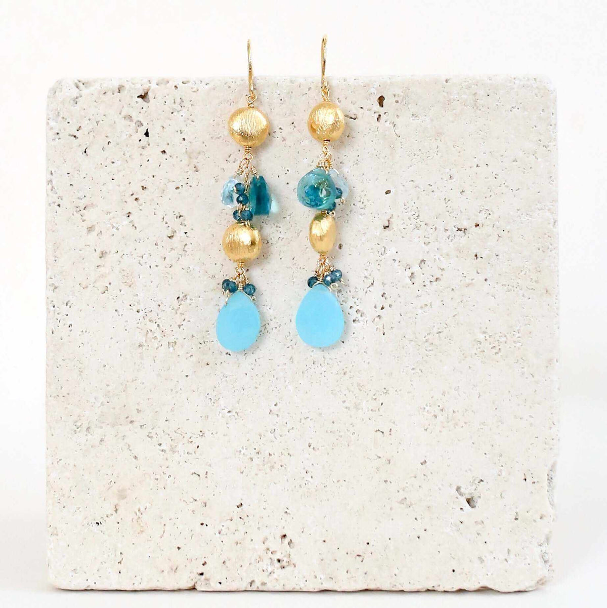 Blue Chalcedony &amp; Aquamarine Gold Drop EarringsGorgeous gold drop earrings. Made with blue chalcedony, aqua blue quartz and aquamarine gemstones.- 2.5" long- French hooks- 14k gold plated .925 fine Italian sterliEarringsPARKEN JEWELRYVettedArcBlue Chalcedony &amp; Aquamarine
