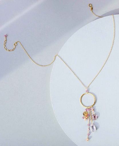 The Ammil Necklace with rose quartz and pink tourmaline gemstones on gold hoop pendant