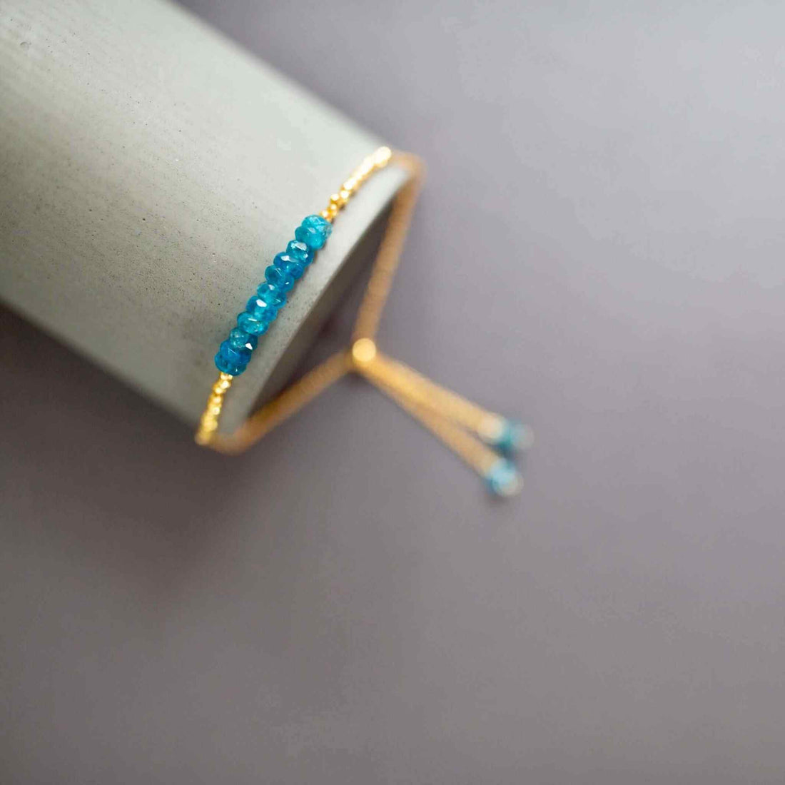 Neon Apatite Adjustable Stacking BraceletNeon Apatite Adjustable Stacking Bracelet &amp;mdash; an authentic gemstone bracelet featuring neon blue apatite stones with gold accents. The adjustable slider clasp fiBraceletsPARKEN JEWELRYVettedArcneon blue apatite meaning