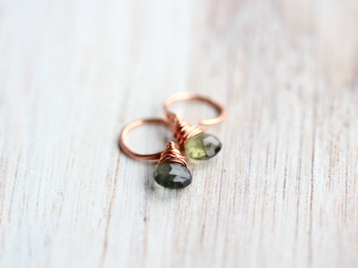 Moss aquamarine dangle hug earrings displayed on neutral background, green gemstone drops