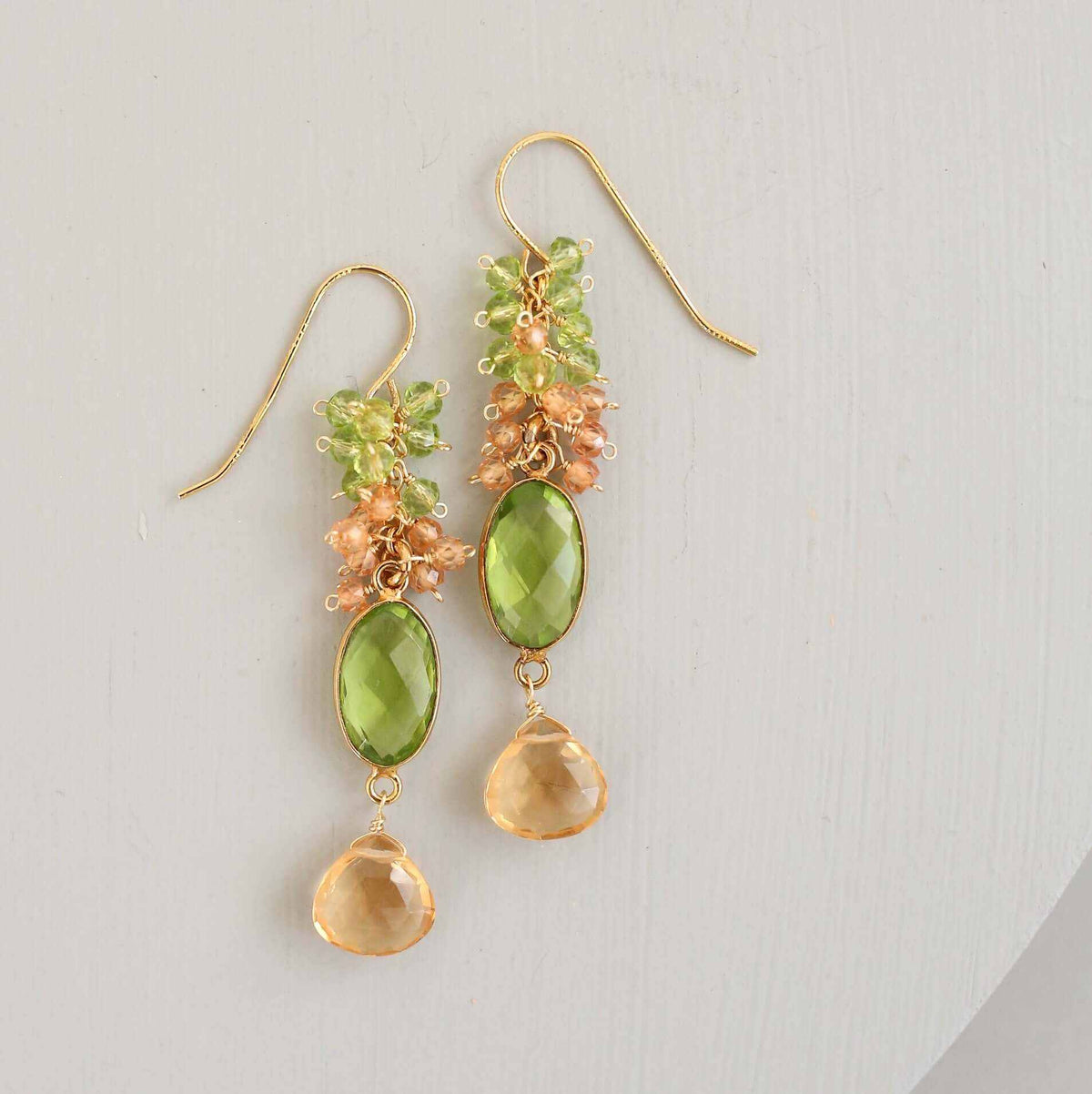 Citrine &amp; Peridot Bezel Cluster EarringsDripping in gems, these long drop earrings are made with a peridot quartz bezel paired with citrine and peridot gemstones.- 2.5" long- French hooks- 14k gold plated EarringsPARKEN JEWELRYVettedArcCitrine &amp; Peridot Bezel Cluster Earrings