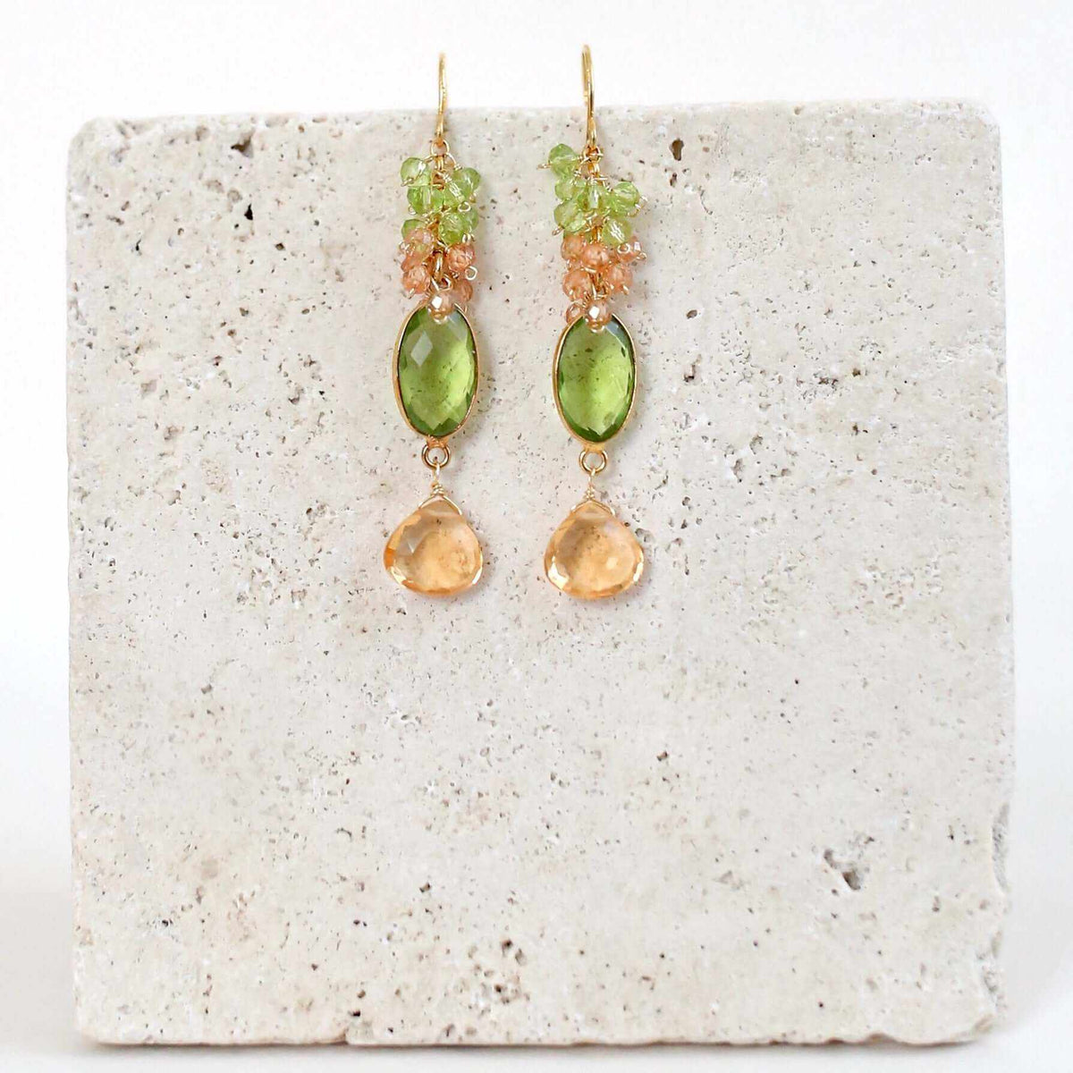 Citrine &amp; Peridot Bezel Cluster EarringsDripping in gems, these long drop earrings are made with a peridot quartz bezel paired with citrine and peridot gemstones.- 2.5" long- French hooks- 14k gold plated EarringsPARKEN JEWELRYVettedArcCitrine &amp; Peridot Bezel Cluster Earrings