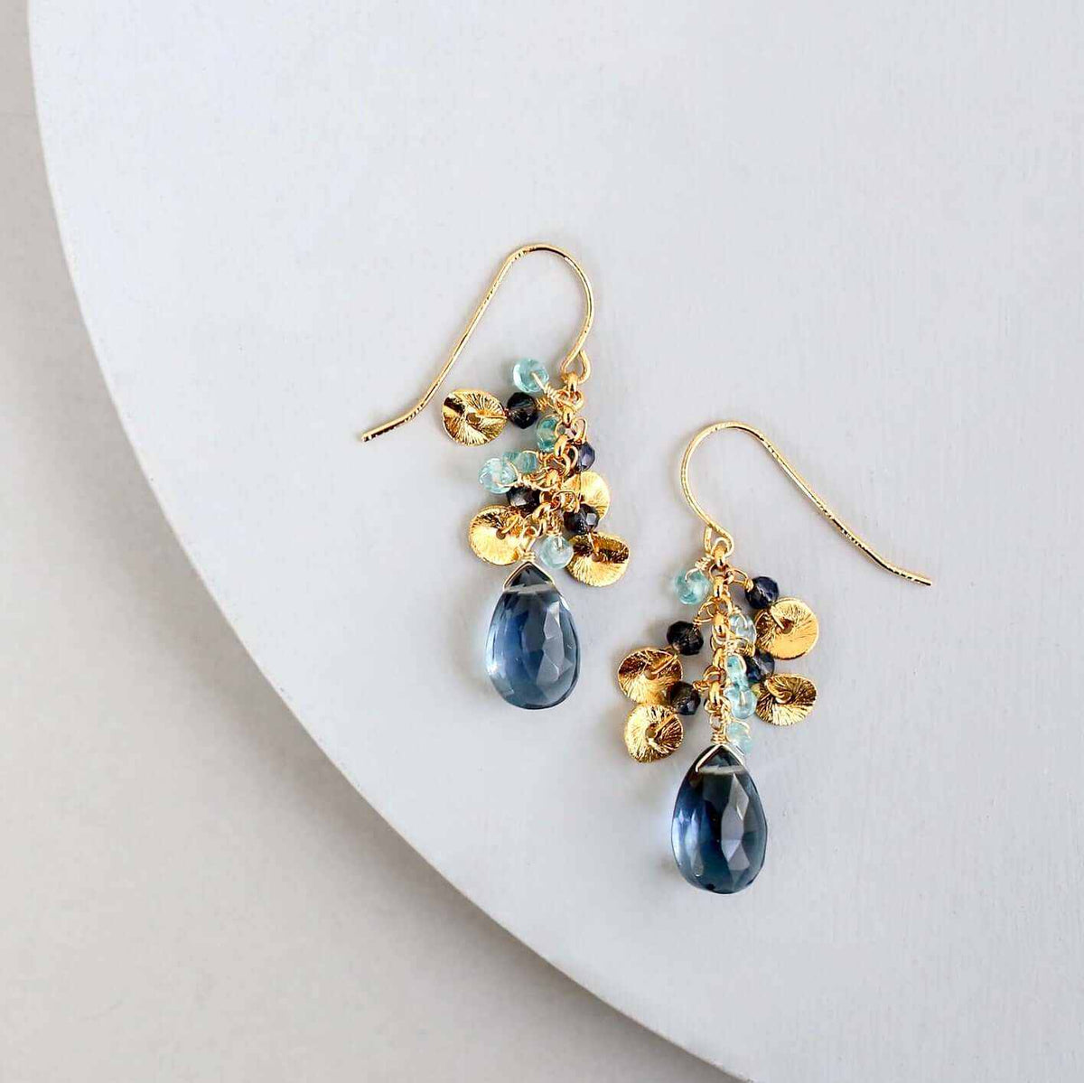 Iolite Aurora EarringsBeautiful small gold earrings made with oval shaped iolite gemstones and a cluster of gold and iolite gemstone accents.
- 1.5" long- French hooks
- 14k gold plated .EarringsPARKEN JEWELRYVettedArcIolite Aurora Earrings