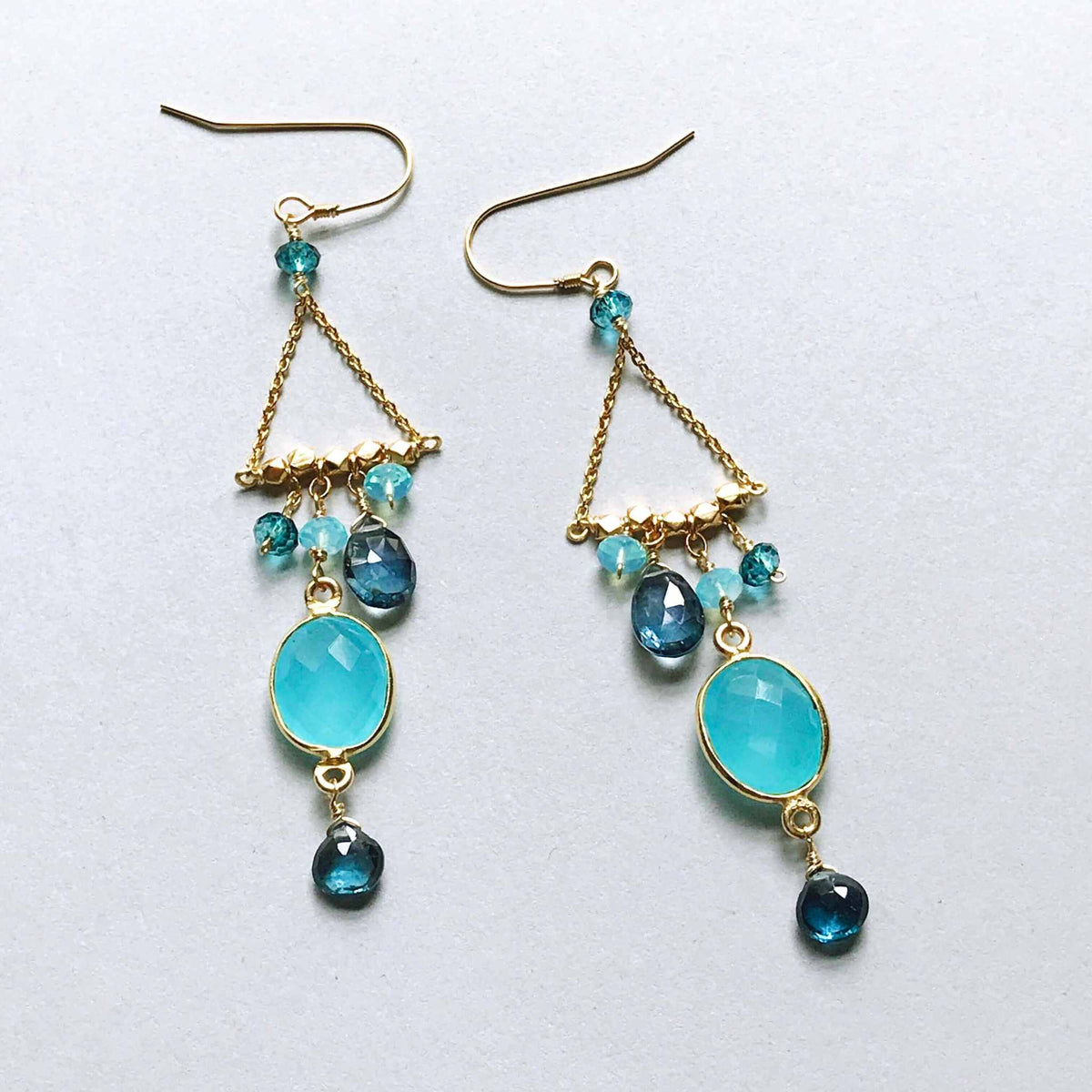 Blue Chandie EarringsOur "chandies" are a modern take on classic chandelier earrings, using gemstone color combos and different stone shapes and sizes.
- Bezel set blue chalcedony gemstoEarringsPARKEN JEWELRYVettedArcBlue Chandie Earrings