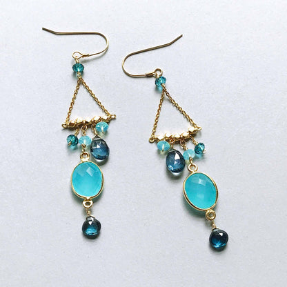 Blue Chandie EarringsOur "chandies" are a modern take on classic chandelier earrings, using gemstone color combos and different stone shapes and sizes.
- Bezel set blue chalcedony gemstoEarringsPARKEN JEWELRYVettedArcBlue Chandie Earrings