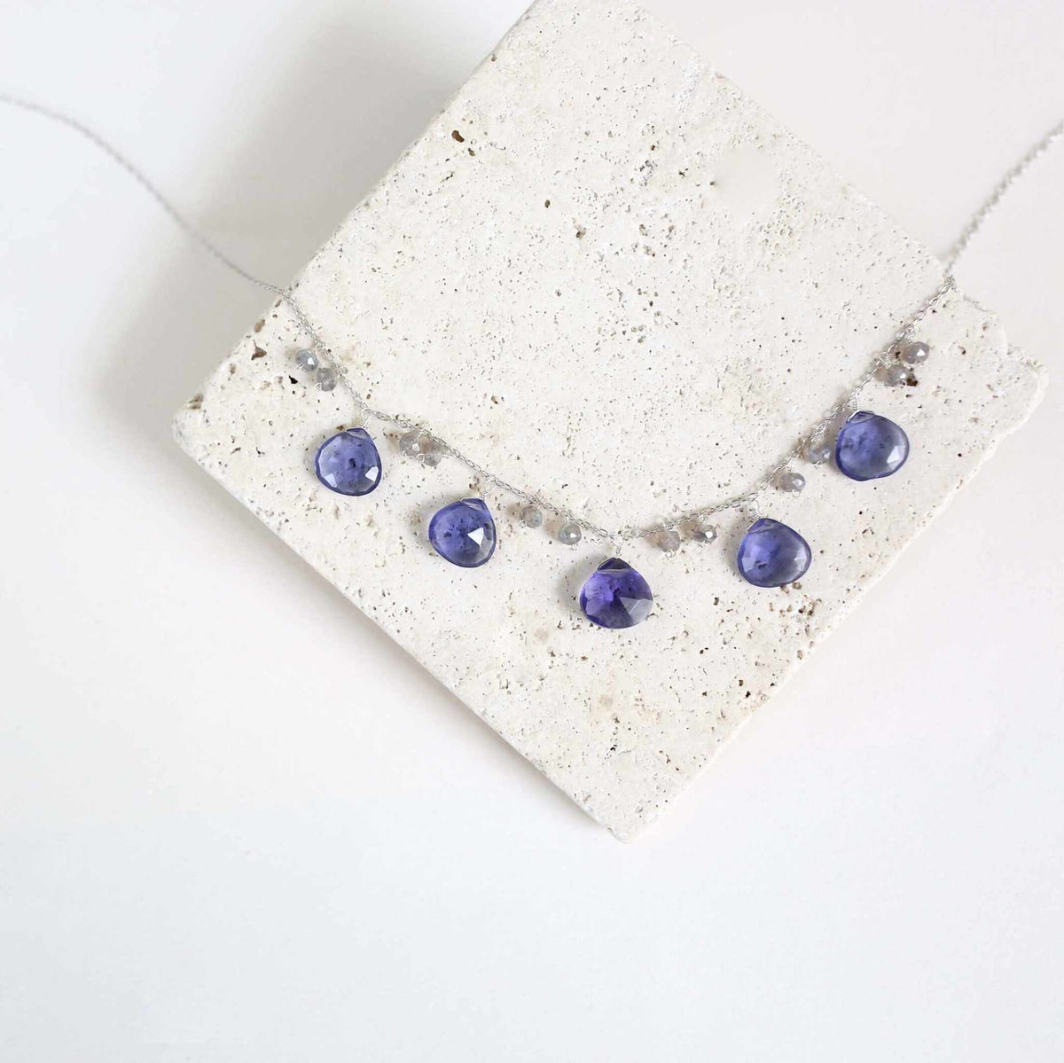 Tanzanite Quartz Silver Sparkler NecklaceA lovely string of sparkling gems.- Tanzanite Quartz &amp;amp; Labradorite gemstones- 16-18" long. Necklace has a 2" extender- Spring ring clasp- Rhodium plated .925 finNecklacesPARKEN JEWELRYVettedArcTanzanite Quartz Silver Sparkler Necklace