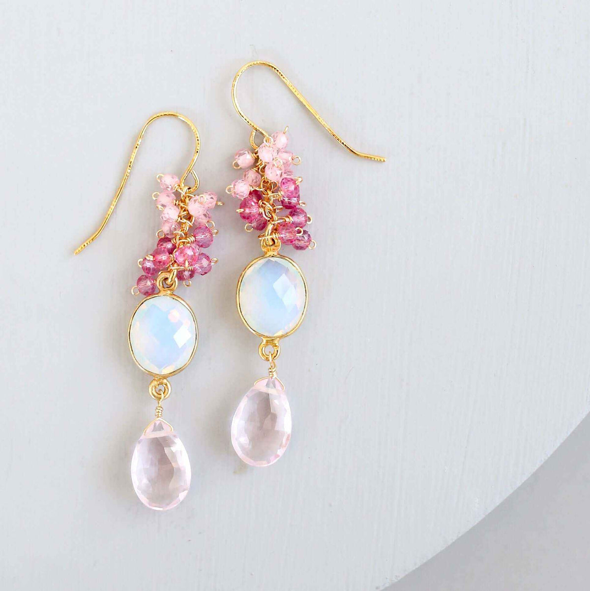Bezel Cluster EarringsDripping in gems, these long gemstone drop earrings are a handmade combination of beautiful bezel set stones and clusters of gems.- 2.5" long- French hooks- 14k goldEarringsPARKEN JEWELRYVettedArcBezel Cluster Earrings