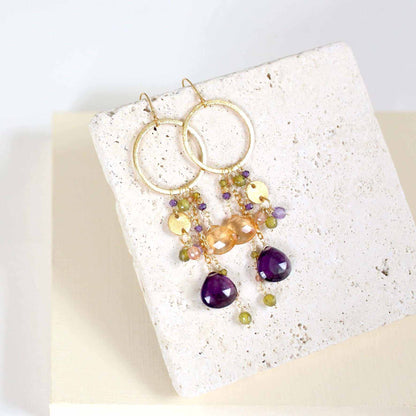 Iolite &amp; Aquamarine Ammil EarringsMultiple strands of lush gems sparkle on a 1" hoop.
- Aquamarine Quartz and Iolite gemstones- 3.5" long- French hooks- 14k gold plated .925 fine Italian sterling silEarringsPARKEN JEWELRYVettedArcIolite &amp; Aquamarine Ammil Earrings