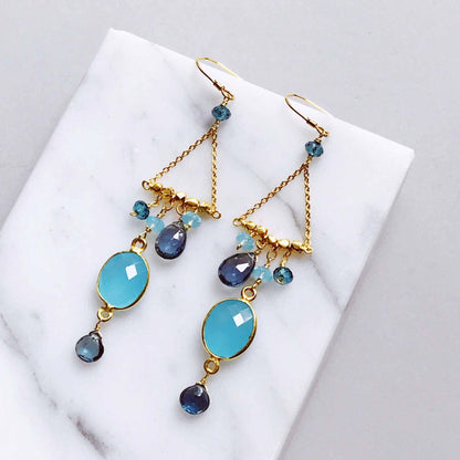Blue Chandie EarringsOur "chandies" are a modern take on classic chandelier earrings, using gemstone color combos and different stone shapes and sizes.
- Bezel set blue chalcedony gemstoEarringsPARKEN JEWELRYVettedArcBlue Chandie Earrings