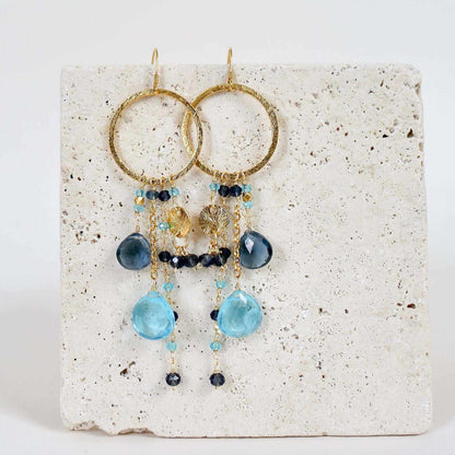 Iolite &amp; Aquamarine Ammil EarringsMultiple strands of lush gems sparkle on a 1" hoop.
- Aquamarine Quartz and Iolite gemstones- 3.5" long- French hooks- 14k gold plated .925 fine Italian sterling silEarringsPARKEN JEWELRYVettedArcIolite &amp; Aquamarine Ammil Earrings
