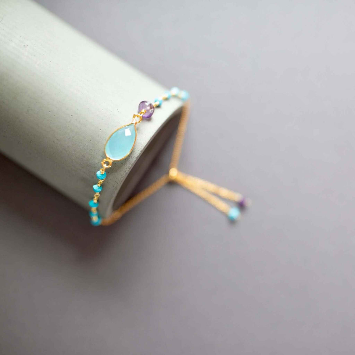 Aqua Blue Chalcedony Adjustable Gold Gemstone BraceletThe ultimate arm candy and completely adjustable to fit anyone. Made with sparkling bezel gemstones and tiny stone accents.
Gorgeous alone or stacked. We&