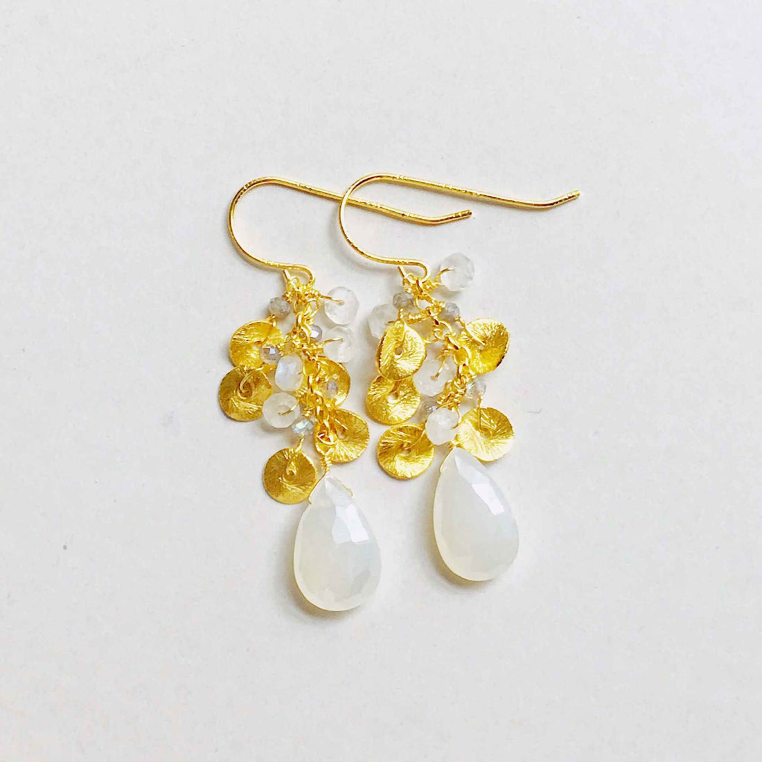 The Aurora Earring - White ChalcedonyBeautiful small gold earrings made with teardrop shaped white chalcedony gemstones and a cluster of gold and quartz gemstone accents.
- 1.5" long- French hooks
- 14kEarringsPARKEN JEWELRYVettedArcThe Aurora Earring
