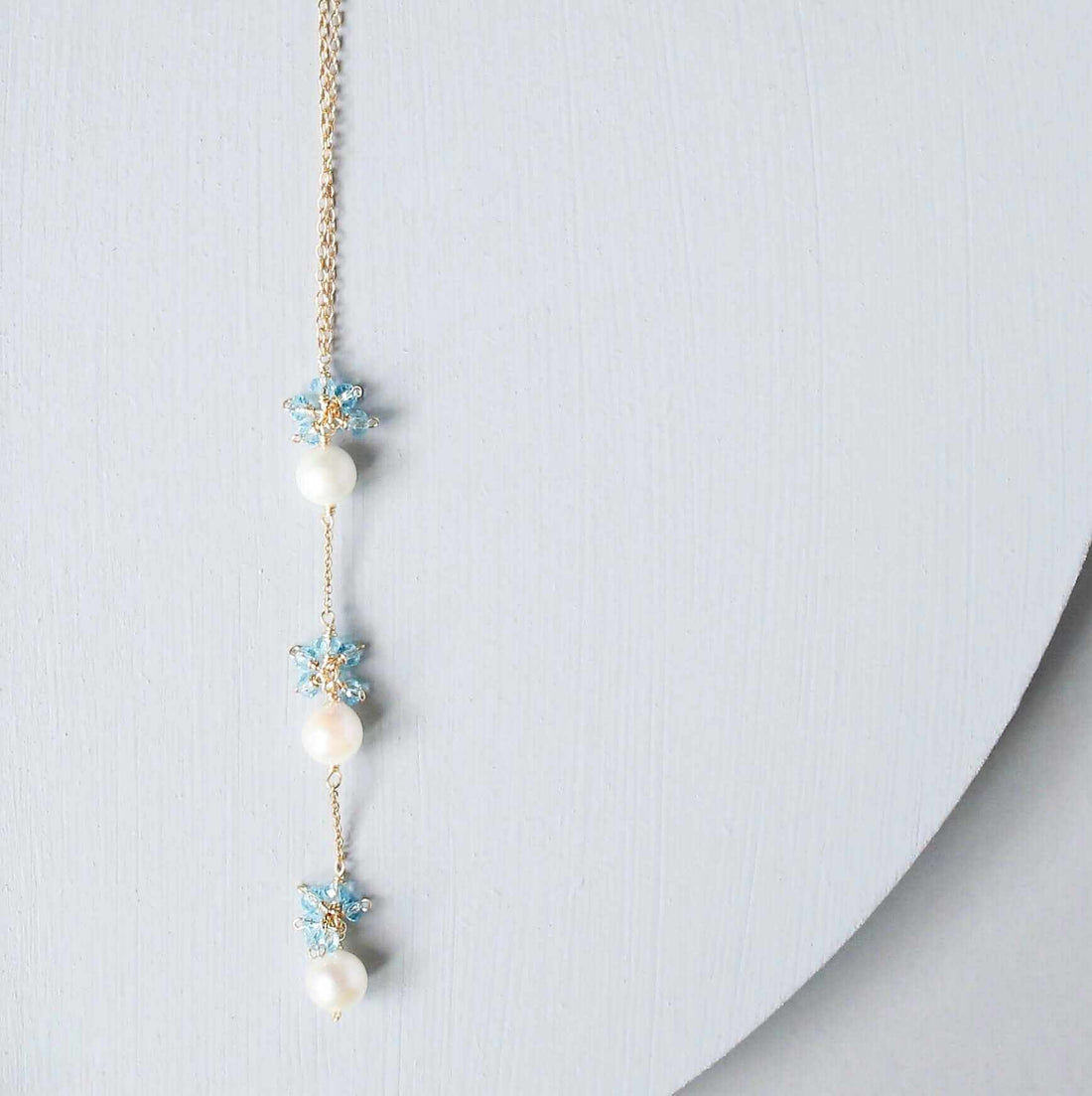 Pearl and Aquamarine Quartz NecklaceY design with 3 white freshwater bead pearls paired with genuine aquamarine quartz  gemstones.
Handmade necklace is 18" long with a 2" extender (up to 20") and 14k gNecklacesPARKEN JEWELRYVettedArcPearl And Aquamarine Quartz Necklace