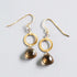 The Airie Earring smoky quartz gold 1.5-inch French hook earrings on a white background